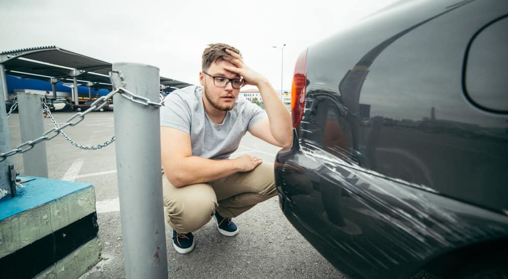 Man frustrated by a scratch on his car